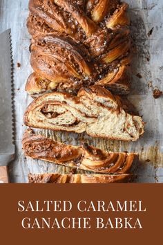 sliced caramel ganache bakka bread on a cutting board with a knife next to it