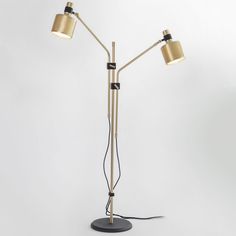 a floor lamp with two lamps attached to the base and one light on each side