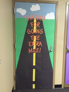 a door decorated with a road and the words thanks for going the extra mile on it