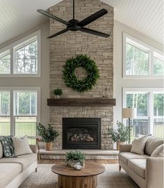 a living room filled with furniture and a fire place in front of a brick fireplace