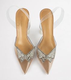 a pair of women's shoes with bows on them