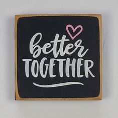 a black and white sign that says,'better together'with a pink heart