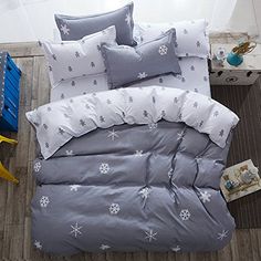 a bed with snowflakes on it is shown in grey and white color scheme