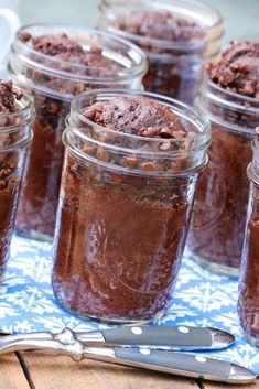 several jars filled with brownies sitting on top of a table