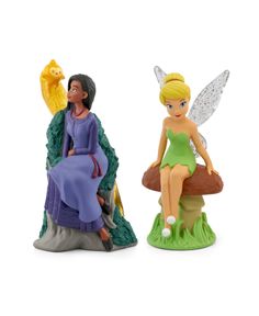 two fairy figurines sitting next to each other