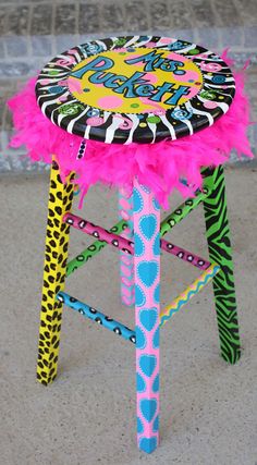 a stool made out of zebra print and pink feathers