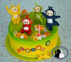 there is a cake decorated with small figurines on the top of it,