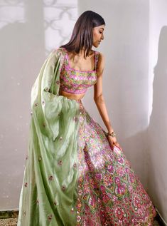 Editor's Note Featuring A Sage Green Silk Organza Lehenga With Tonal Pink Flowers, Mirror And Foil Applique Embroidery. It Comes Along With A Matching Blouse And Self Colour Dupatta. Fabric: Silk Organza Color: Green Care: Dry Clean Only About the Designer Label Aneesh Agarwaal offers regal Indian designs developed with a modern asthetic for the discerning Indian Woman. Luxury Pista Green Lehenga With Resham Embroidery, Luxury Summer Lehenga With Floral Embroidery, Luxury Pista Green Choli With Floral Embroidery, Luxury Multicolor Floral Embroidered Choli, Luxury Floral Embroidered Choli For Spring, Pink And Green Lengha, Green Mehendi Outfits For Bride, Pink And Green Lehenga, Sage Green Lehenga