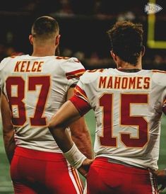 two football players standing next to each other