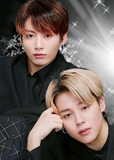 two young men are posing for a photo in front of a black background with silver snowflakes