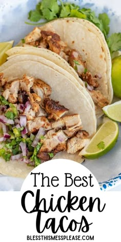 the best chicken tacos with limes and cilantro on the side in a white plate