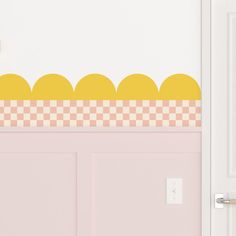 a white door with a yellow and pink wall decal