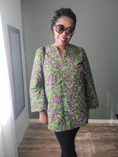 This beautiful African print tunic is made out of 100% wax cotton. It is an easy pull on top with no zippers or buttons. It can be worn for any occasion by styling it differently. Include your measurements in the order notes so we can make sure you are selecting the right fit. DETAILS & CARE - Full Length 30 inches - Sleeve length 24 inches - V-neck - Three-quarter sleeves - Pleat in the back - 100% wax cotton - Hand or machine wash cold recommended to preserve color brilliance Green Floral Print Long Sleeve Tunic, Fall Cotton Blouse With Split Neck, Green Long Sleeve Tunic With Floral Print, Cotton Split Neck Blouse For Fall, Long Sleeve Blouse With Block Print And Relaxed Fit, Green Block Print Long Sleeve Blouse, Green Long Sleeve Block Print Blouse, Long Sleeve Cotton Blouse With Batik Print, Ladies Long Top