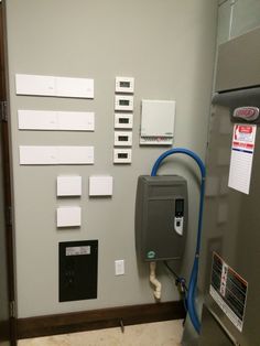 an electrical panel is shown with several different types of switches and wires on the wall