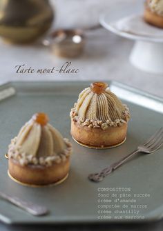 three small desserts on a plate with silverware