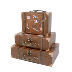 three brown suitcases stacked on top of each other in front of a white background