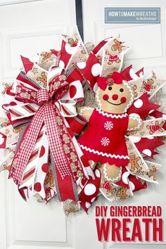 a red and white wreath with a gingerbread doll hanging on it's front door