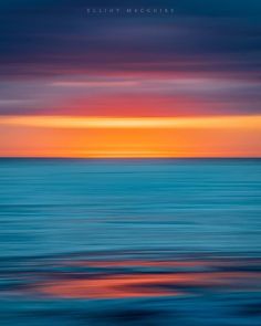 an orange and blue sunset over the ocean