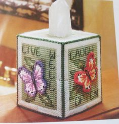 a tissue box with two butterflies on it