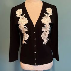 Inc Black Cardigan Sweater With Sheer Creme Appliqus & Rhinestone Button Closure. New Without Tags. Never Worn. Pleated Shoulder 18” Pit To Pit 22” Shoulder To Hem. This Is A Beautiful Quality Sweater. Wear Alone Or Over Tank. Medium Elegant Cream Button-up Sweater, Elegant Cream Button-up Cardigan, Elegant Spring Cardigan With Buttons, Elegant Spring Sweater With Button Closure, Black Cardigan Sweater, Floral Applique, Black Cardigan, Inc International Concepts, Black Cream