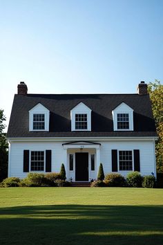 a large white house with black roof and windows