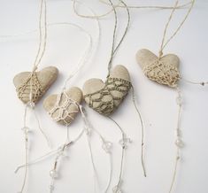 three hearts made out of rocks and string