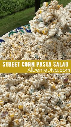 a plate full of corn salad with the words street corn pasta on top and above it