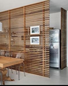 a kitchen with wooden slats on the wall