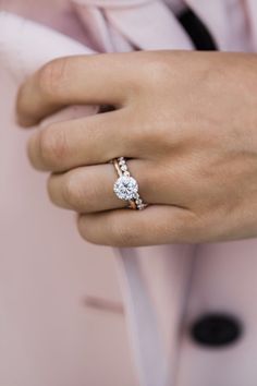 a close up of a person wearing a diamond ring