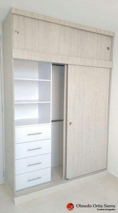 a white closet with drawers and shelves in the middle of an empty floored room