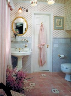 a bathroom with pink and white tile floors