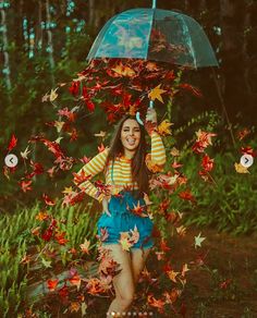 a woman holding an umbrella surrounded by leaves