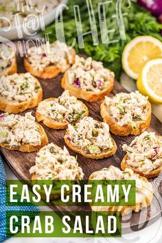 an easy creamy crab salad recipe with lemons and parsley on the side