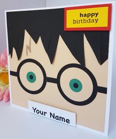 a birthday card with the name harry potter on it and a flower in front of it