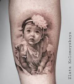 a baby with a flower in her hair on the leg