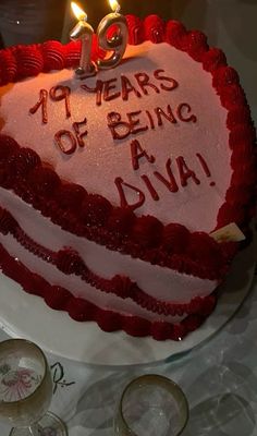 a red and white cake with candles on it that says 40 years of being diya