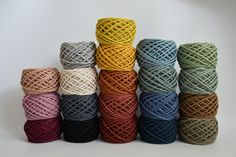 several colors of twine are stacked on top of each other