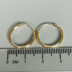 16mm sterling silver endless ear hoops, dipped in gold. Size: 1.5 x 16 mm These earrings are made of real 925 hypoallergenic sterling silver, dipped in real gold. Will be packaged in a gift box. Please let me know if you don't want it in one. I can write out a message from you to the receiver if needed. Please be free to contact me at... bhavnakwintra1956@gmail.com More hoops: https://www.etsy.com/your/shops/TheSilverGame/tools/listings/section:26305414 More earrings: https://www.etsy.com/your/s Gold Huggie Jewelry With Simple Design, Gold Simple Design Huggie Jewelry, Minimalist Small Hoop Earrings Cadmium-free, Adjustable Nickel-free Round Huggie Earrings, Gold Hypoallergenic Hoop Cartilage Earrings, Nickel-free Gold Round Cartilage Earrings, Adjustable Gold Hoop Huggie Earrings, Simple Small Adjustable Hoop Earrings, Adjustable Round Yellow Gold Cartilage Earrings