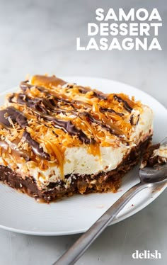 a piece of cake on a plate with a fork next to it and the words samoa dessert lasagna above it