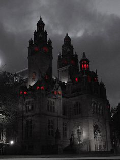 an old building lit up with red lights