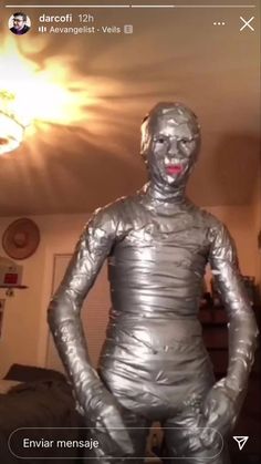 a silver statue is standing in the middle of a room