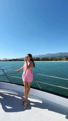 a woman standing on the deck of a boat