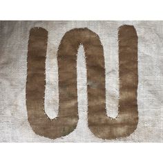 the word 100 is written on a piece of fabric