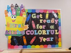 a bulletin board with crayons on it that says get ready for a colorful year