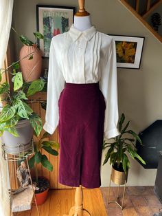 This is such gorgeous deep burgundy red velvet skirt with a straight silhouette and hits below the knee. It has two front hip pockets, zips up the back, and has a kick pleat in both the front and back for easy movement as the fabric has no stretch.  Label: Plumtree - Wescott Canada Made in Canada Size: tagged 9/10 - fits approximately a 26 waist Measurements (taken flat): Waist - 13" Hips - 17" Hem - 21" Length - 27.5" Good vintage condition Feel free to message me for more measurements, picture Vintage Red Skirt For Work, Vintage Red Skirt For Workwear, Vintage Long Red Skirt, Vintage Red Full Skirt Bottoms, Retro Red Lined Skirt, Retro Red Pleated Skirt, Straight Midi Skirt, Kick Pleat Skirt, Vintage Red Lined Skirt