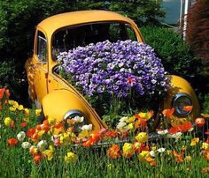 an old yellow car with flowers growing out of it's hood and the words you wouldn't let anyone take your favorite things so do, so don't allow negative thoughts to take your joy