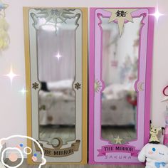 the mirror is pink and gold in color with stars on it, next to a stuffed animal