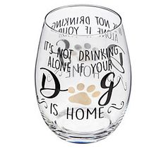 a wine glass with writing on it and a dog's paw in the bottom