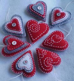 red and white heart ornaments are arranged in a circle