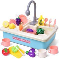 a toy kitchen sink filled with lots of colorful dishes and utensils in it